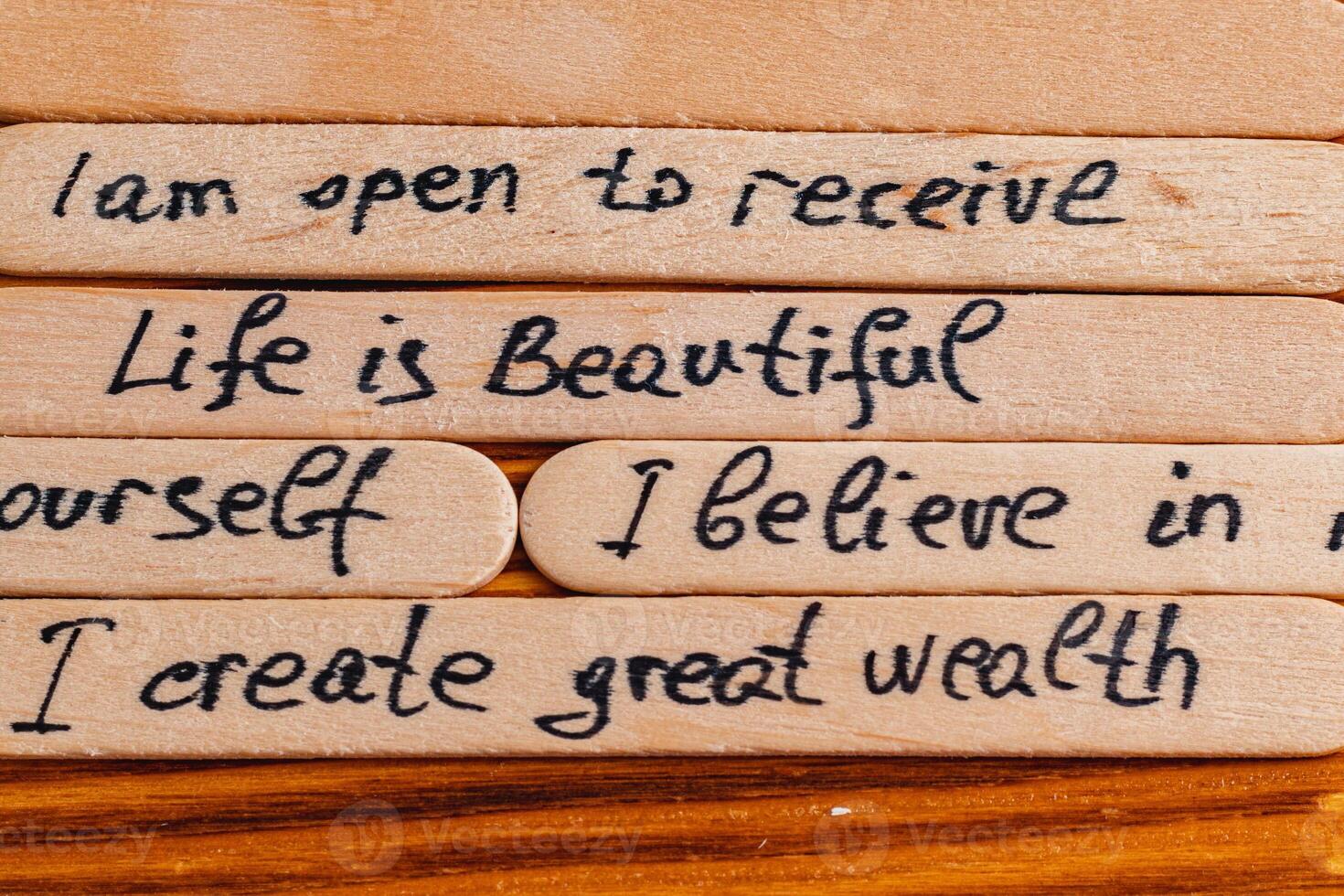 Positive thoughts for increasing selfesteem on wooden posts on wooden background photo