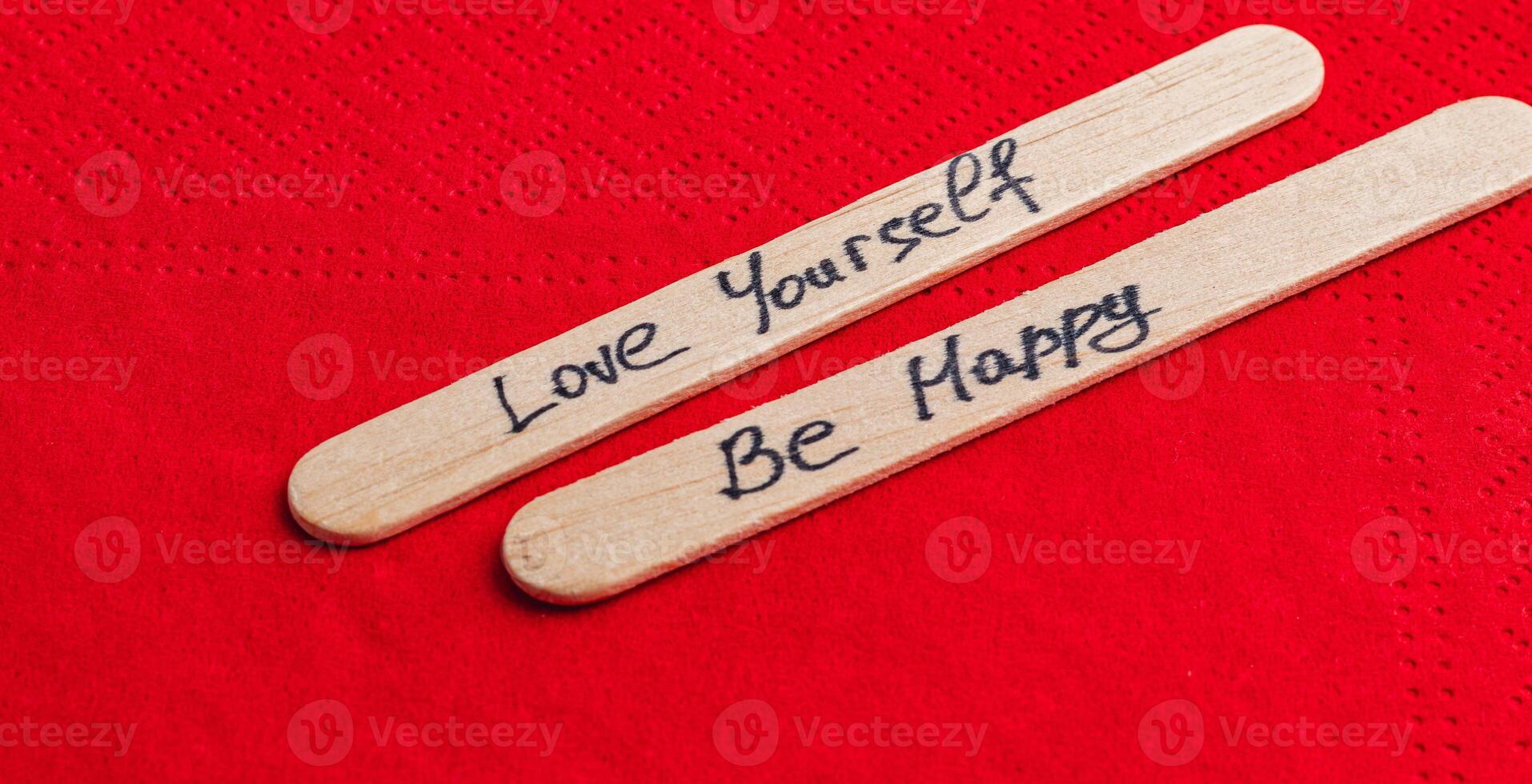 Positive thoughts for increasing self-esteem on wooden posts on red background photo
