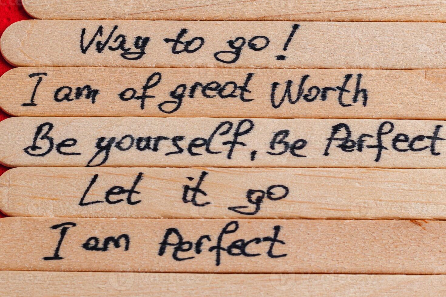 Positive thoughts for increasing selfesteem on wooden posts on wooden background photo
