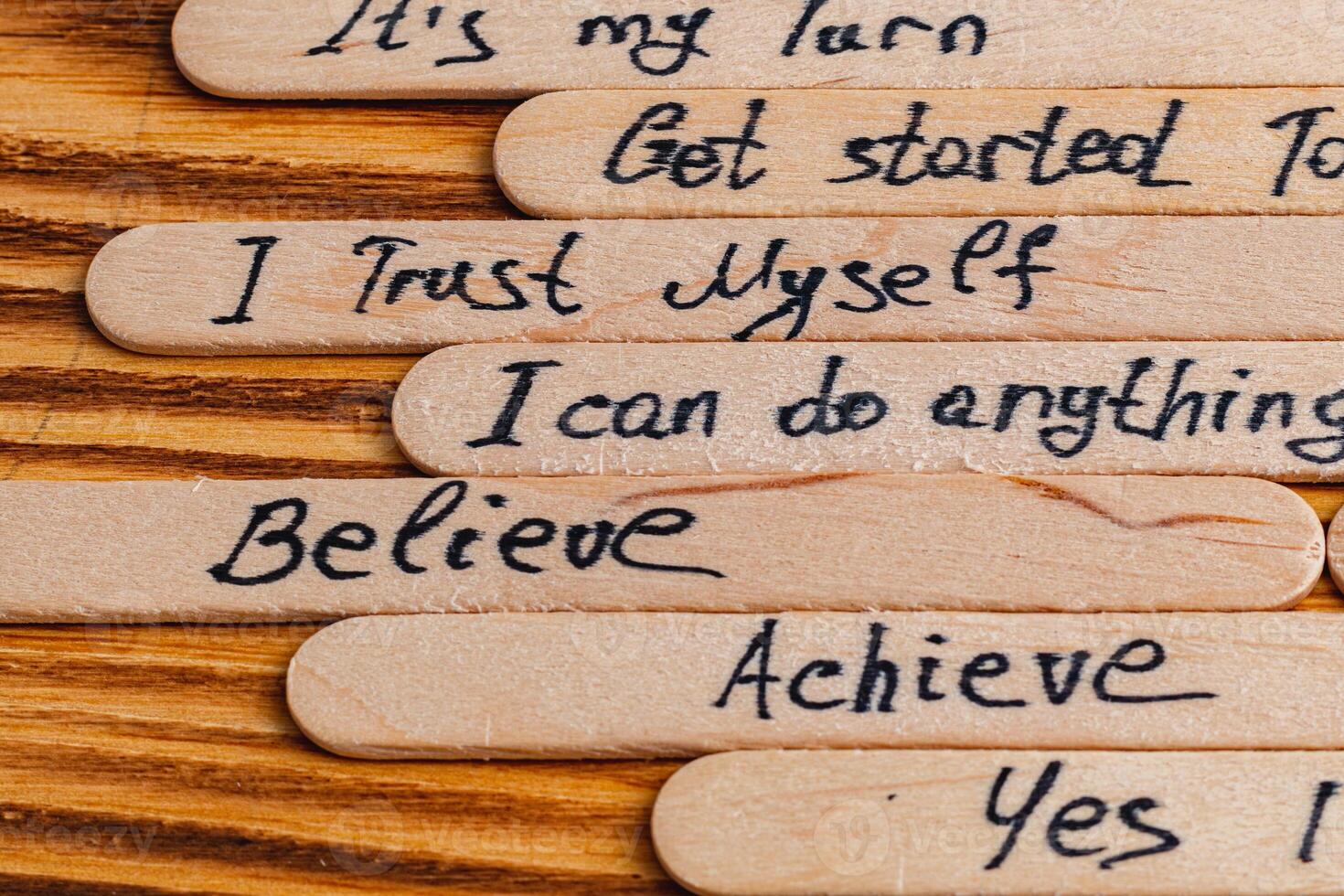 Positive thoughts for increasing selfesteem on wooden posts on wooden background photo