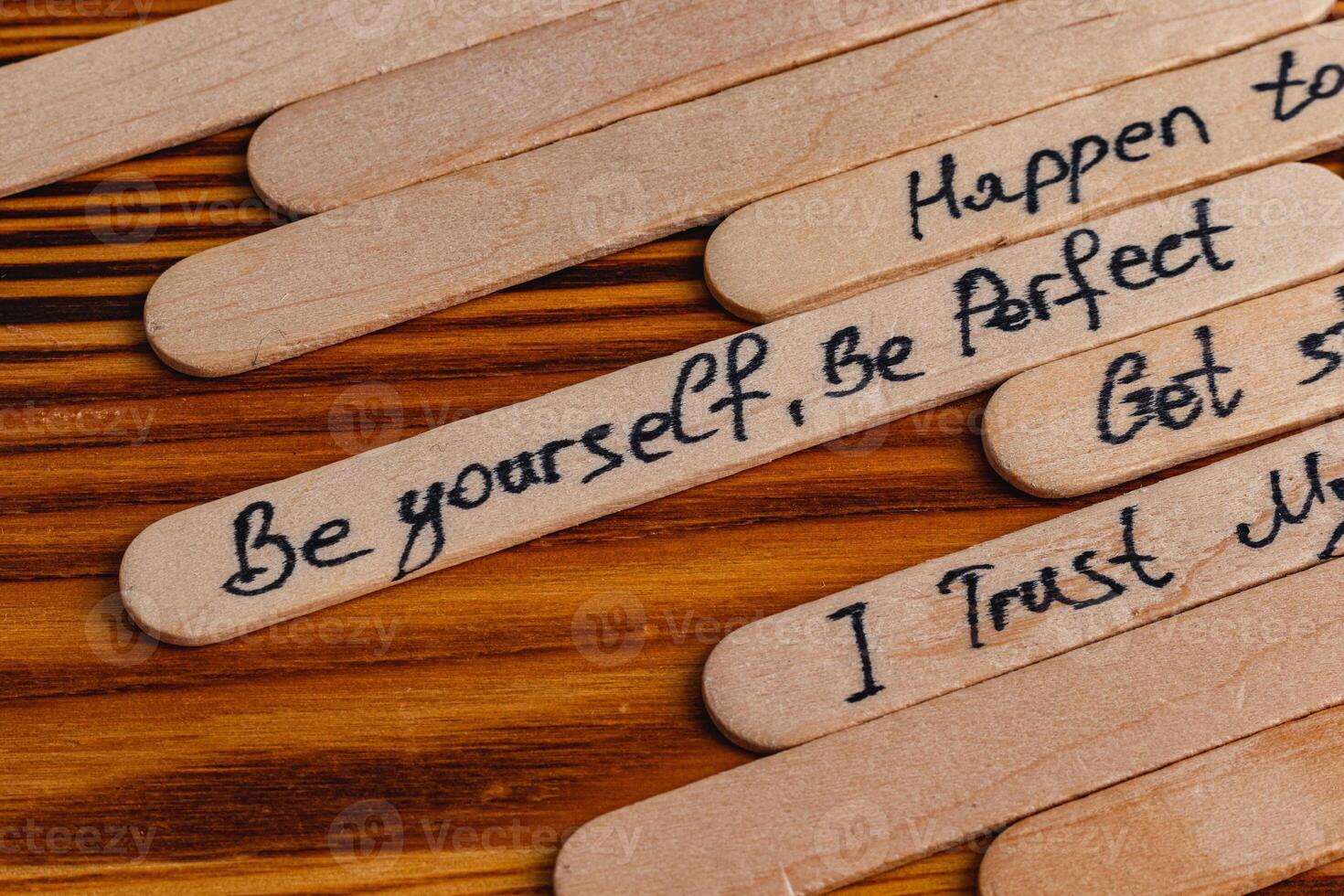 Positive thoughts for increasing selfesteem on wooden posts on wooden background photo