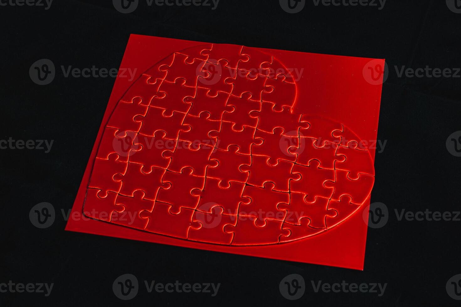 Conceptual photo of puzzle, heart shape for Valentine's Day on black background