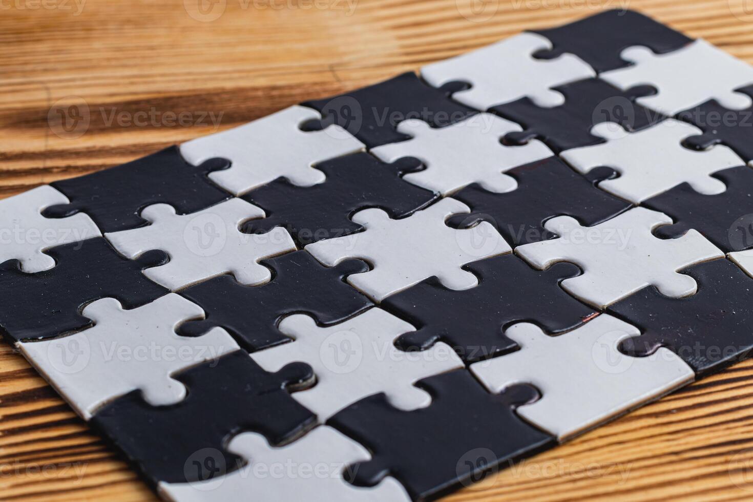 Black and white puzzle, teamwork challenge concept photo