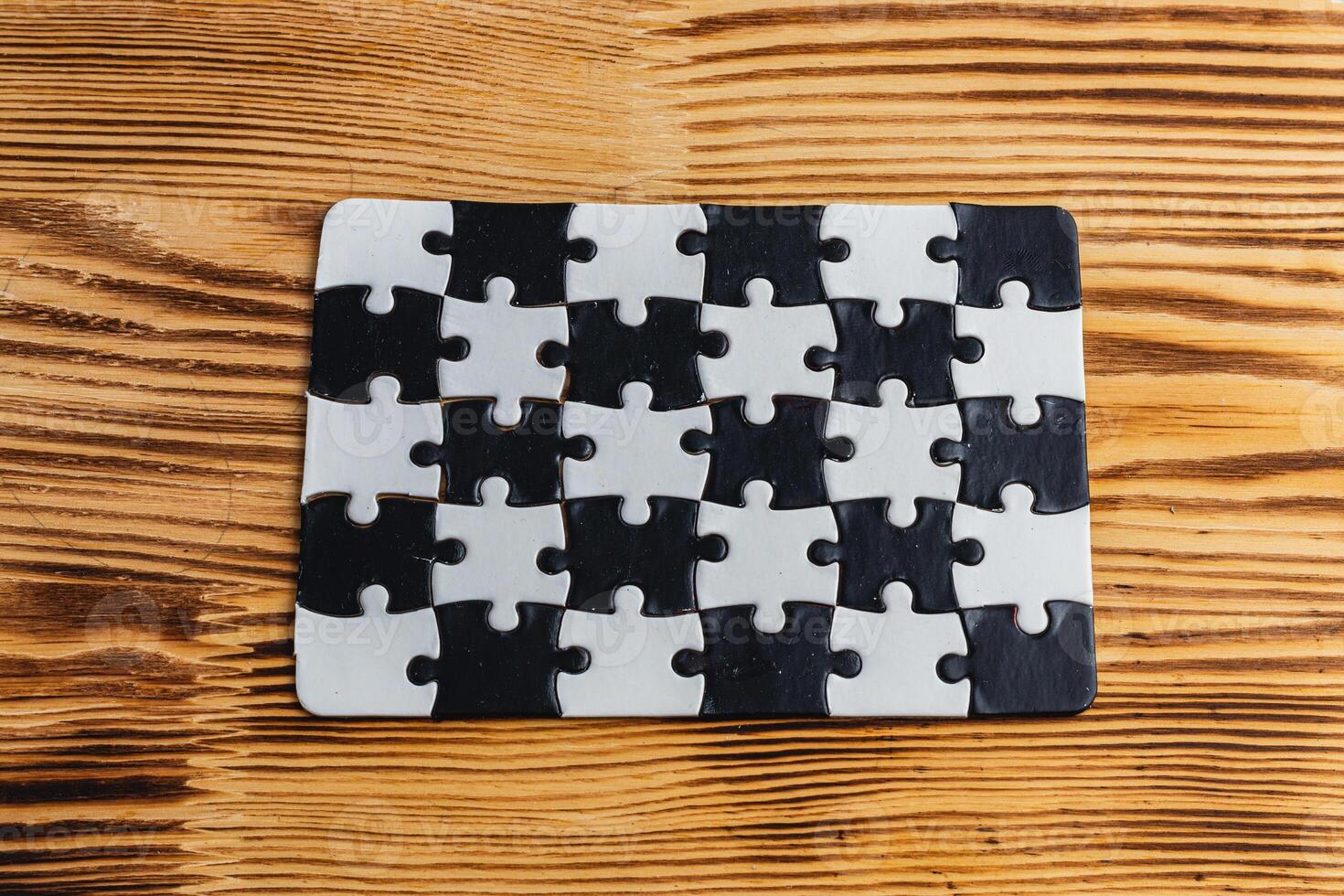 Black and white puzzle, teamwork challenge concept photo