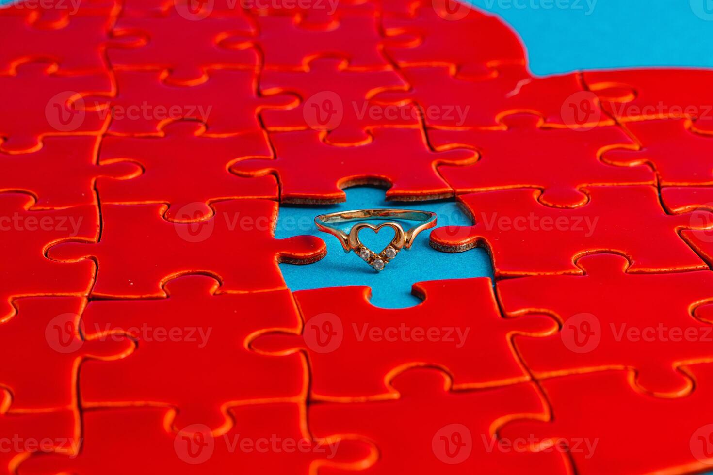 Love concept. Broken heart puzzle with wedding ring, missing puzzle pieces photo
