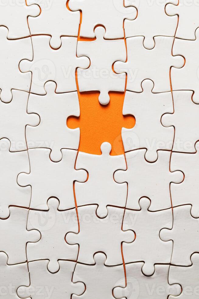 Conceptual photo of a puzzle, missing piece, on an orange background