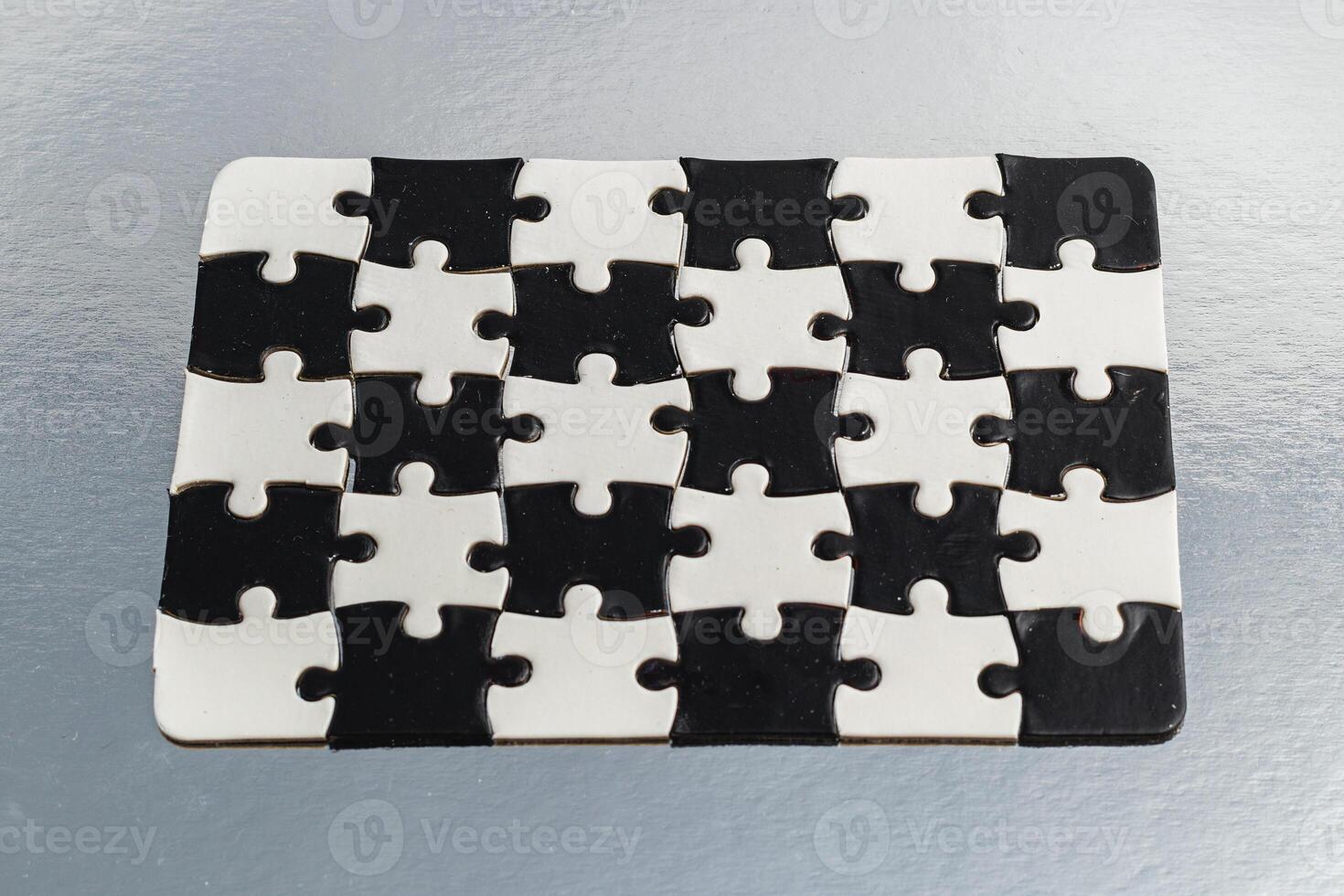 Black and white puzzle, teamwork challenge concept photo
