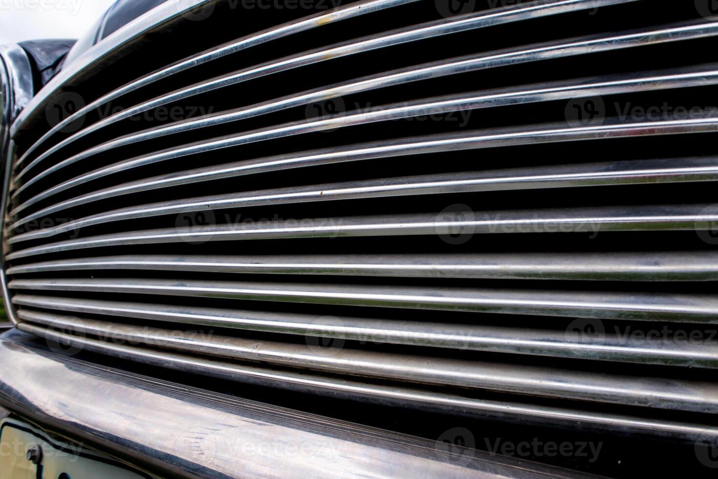 Close up to shiny front grill of car photo