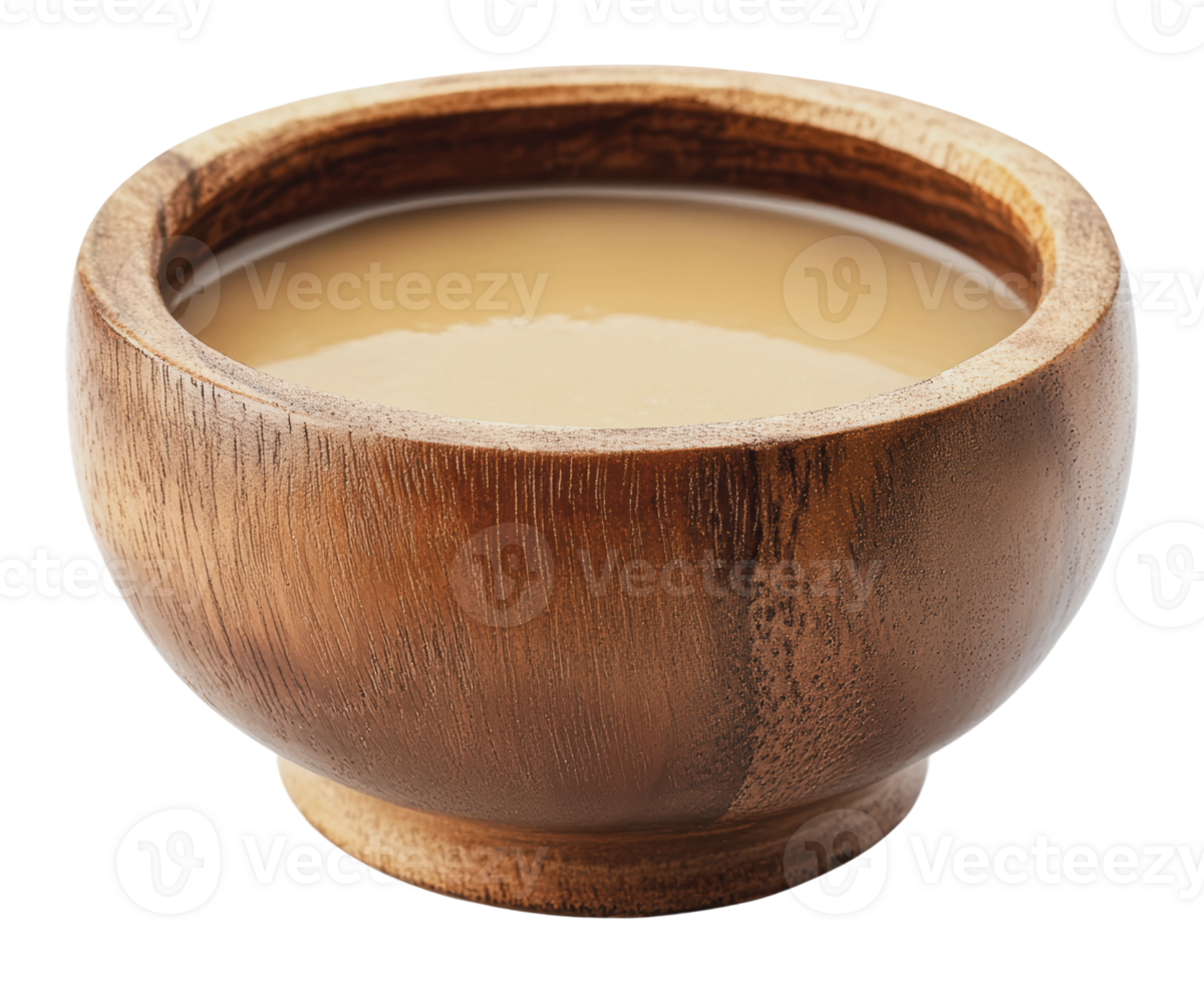 Wooden bowl filled with creamy beverage on table png