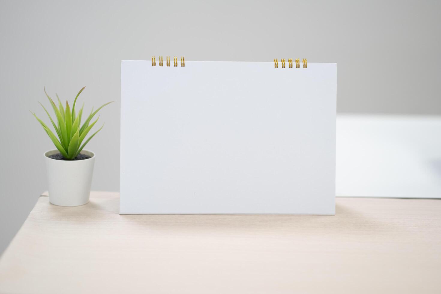 Blank desk calendar on table in mock up and copy space concept. photo