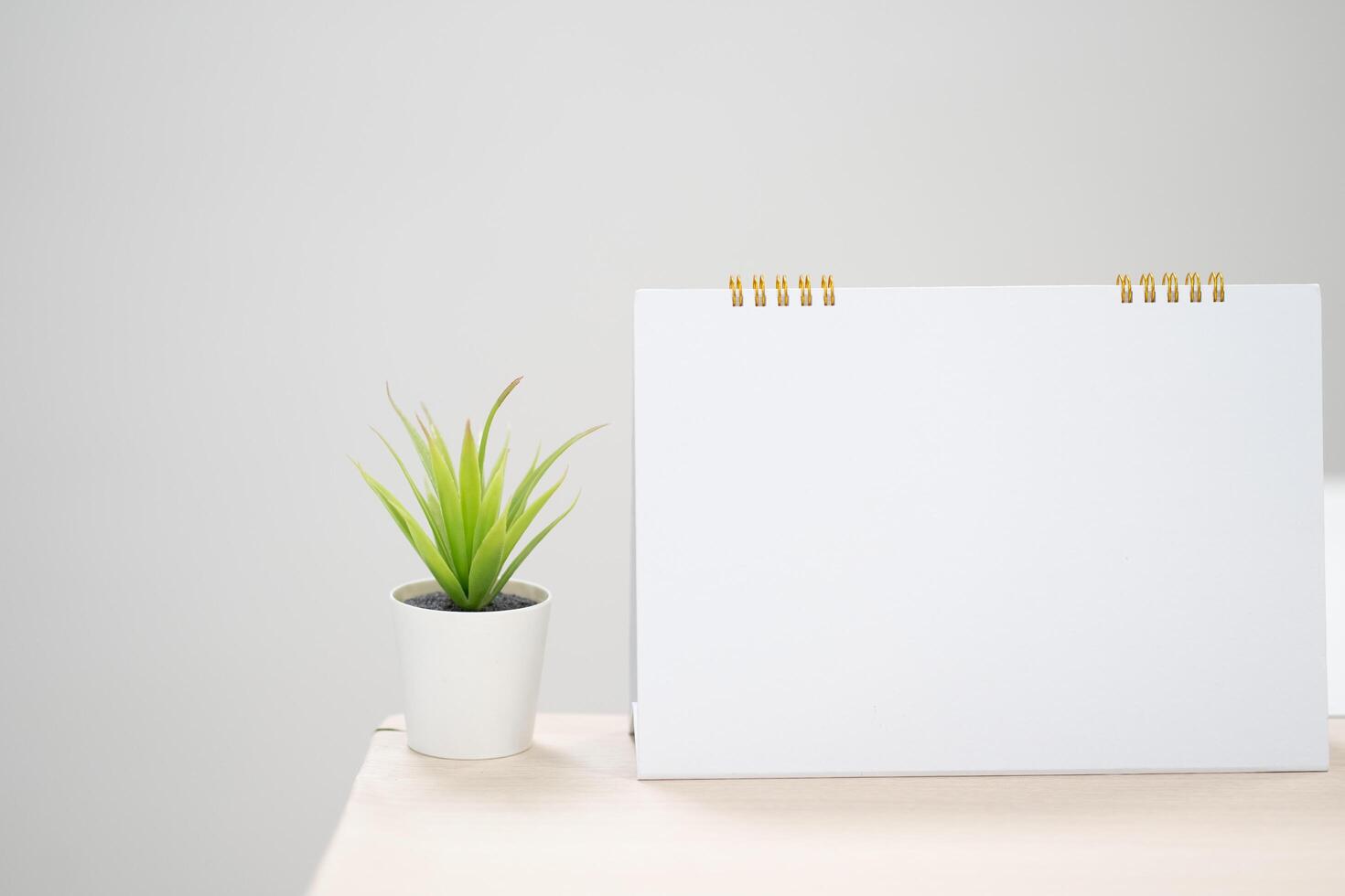 Blank desk calendar on table in mock up and copy space concept. photo