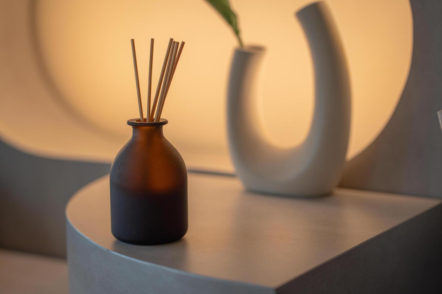 aromatherapy and home perfume concept - aroma reed diffuser on wooden shelf photo