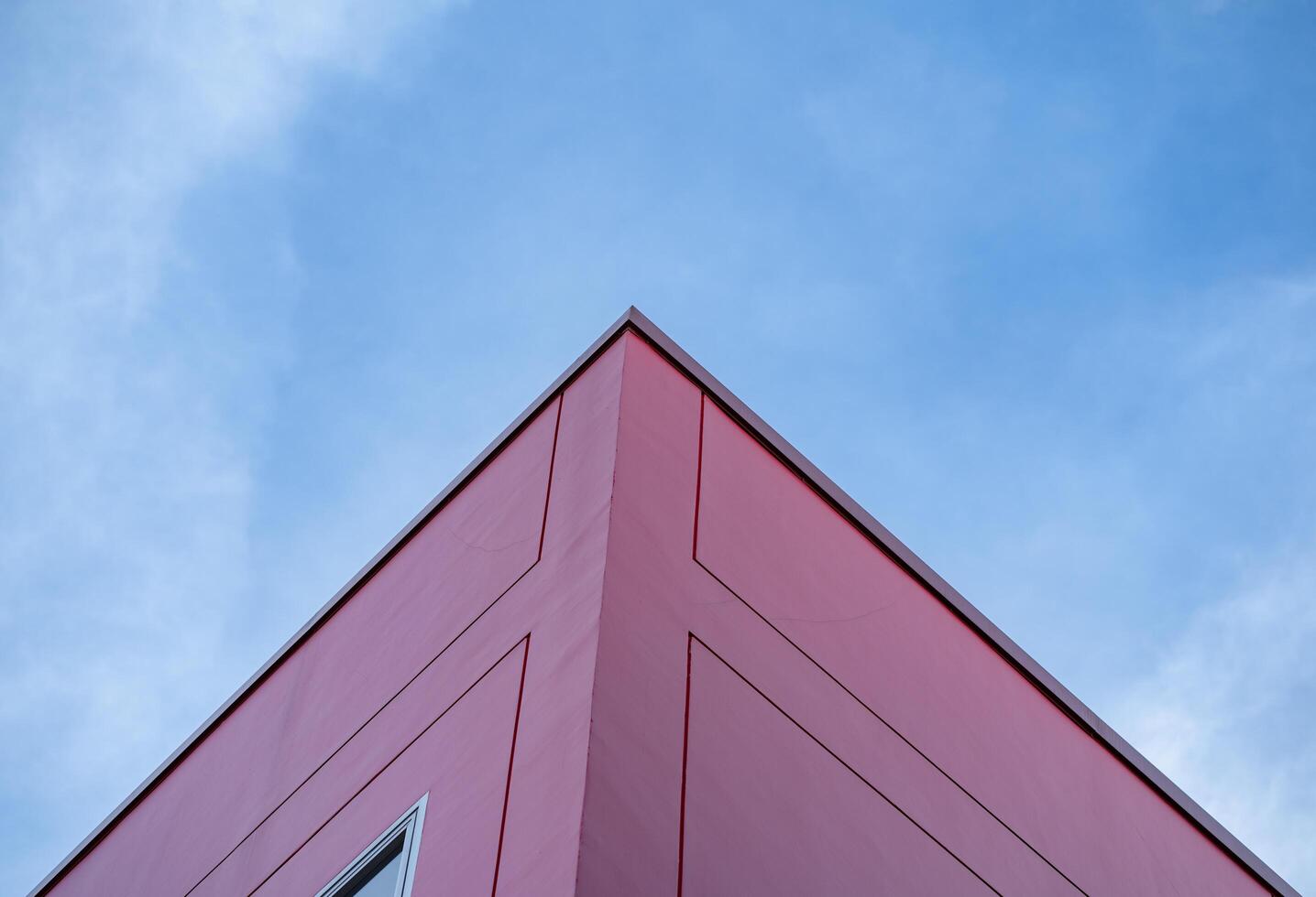 Colorful red building architecture and blue sky, bright sunlight, abstract background photo