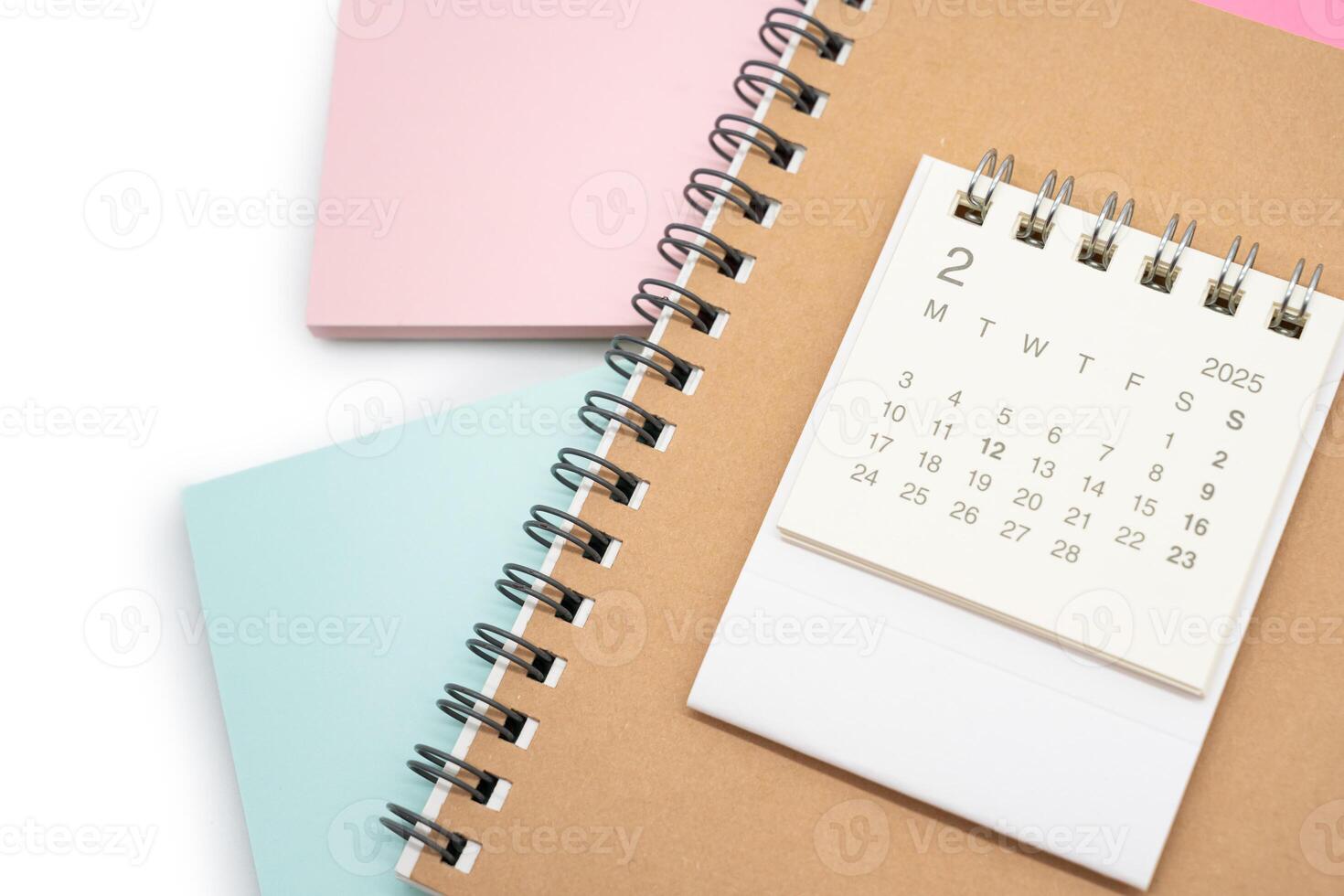 Simple desk calendar for FEBRUARY 2025 with office supplies. Calendar concept with copy space. 2025 FEB calendar. photo