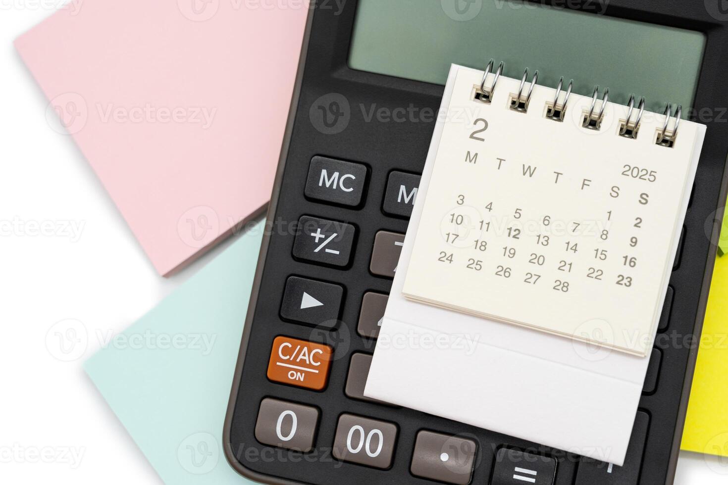Simple desk calendar for FEBRUARY 2025 with office supplies. Calendar concept with copy space. 2025 FEB calendar. photo