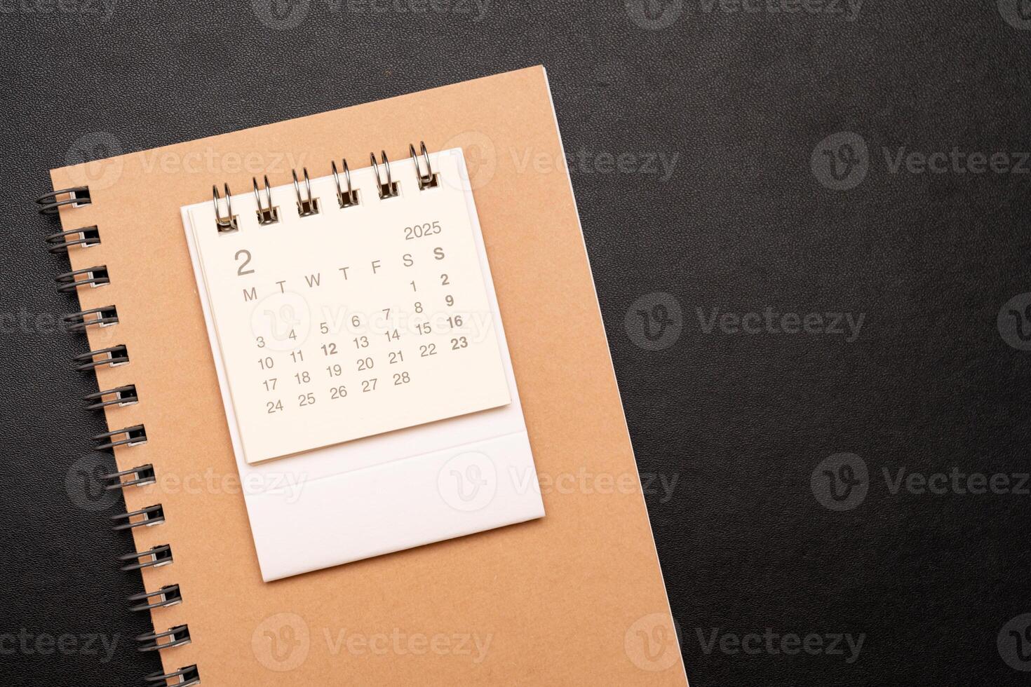 Simple desk calendar for FEBRUARY 2025 with office supplies. Calendar concept with copy space. 2025 FEB calendar. photo