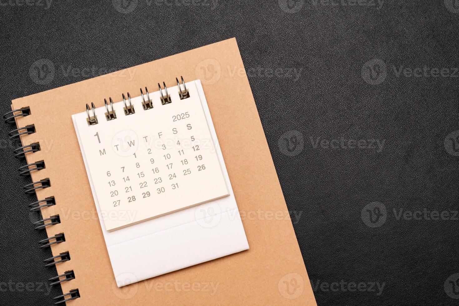 Simple desk calendar for JANUARY 2025 with office supplies. Calendar concept with copy space. 2025 JAN calendar. photo