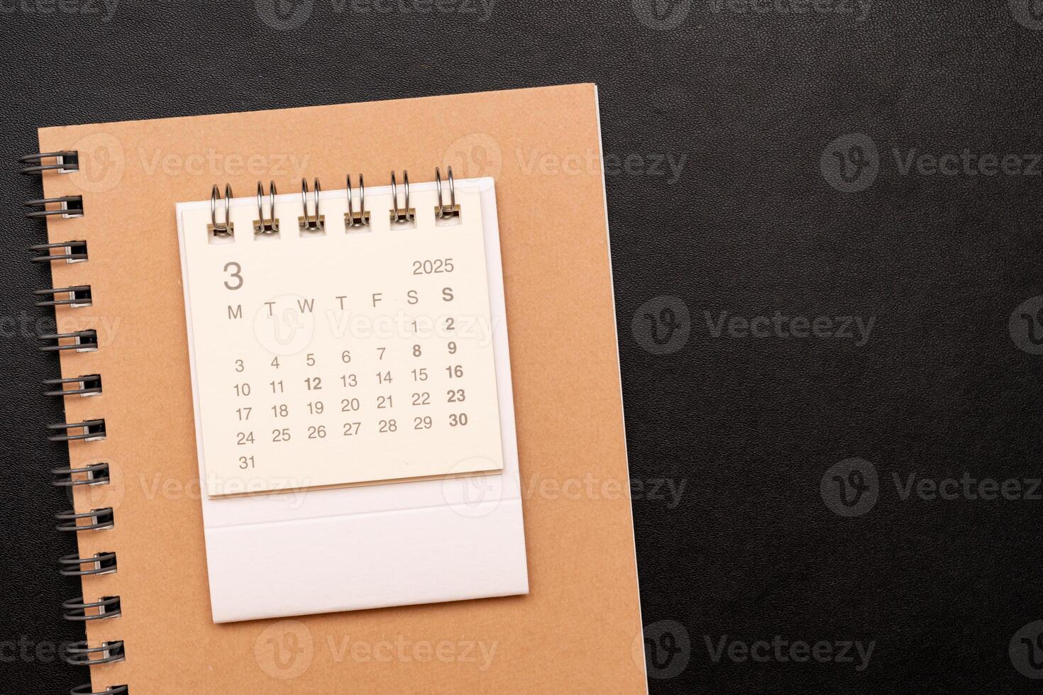 Simple desk calendar for MARCH 2025 with office supplies. Calendar concept with copy space. 2025 MAR calendar. photo