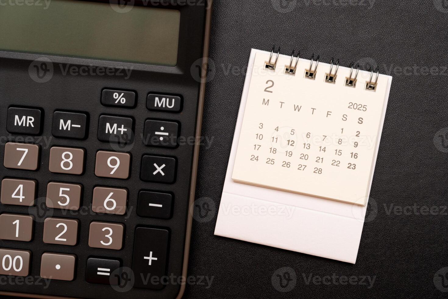 Simple desk calendar for FEBRUARY 2025 with office supplies. Calendar concept with copy space. 2025 FEB calendar. photo