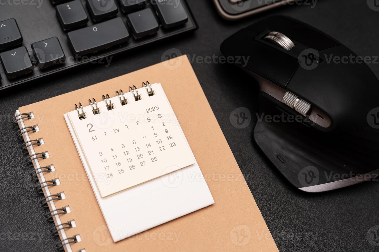Simple desk calendar for FEBRUARY 2025 with office supplies. Calendar concept with copy space. 2025 FEB calendar. photo