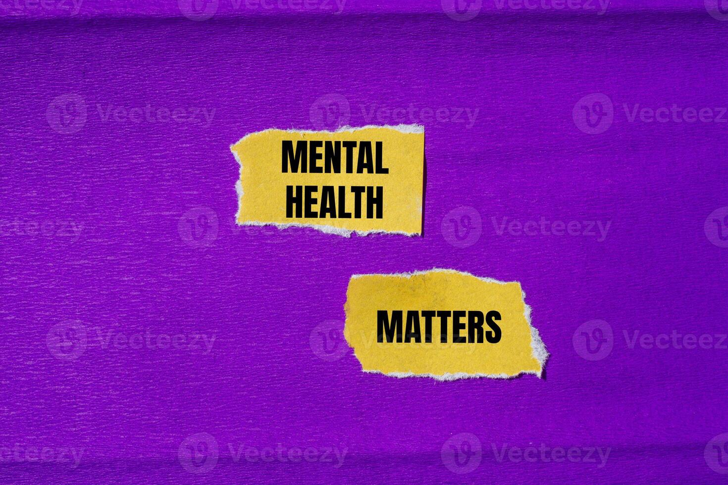 Mental health matters message written on ripped torn yellow paper pieces with purple background. Conceptual mental health matters symbol. Copy space. photo