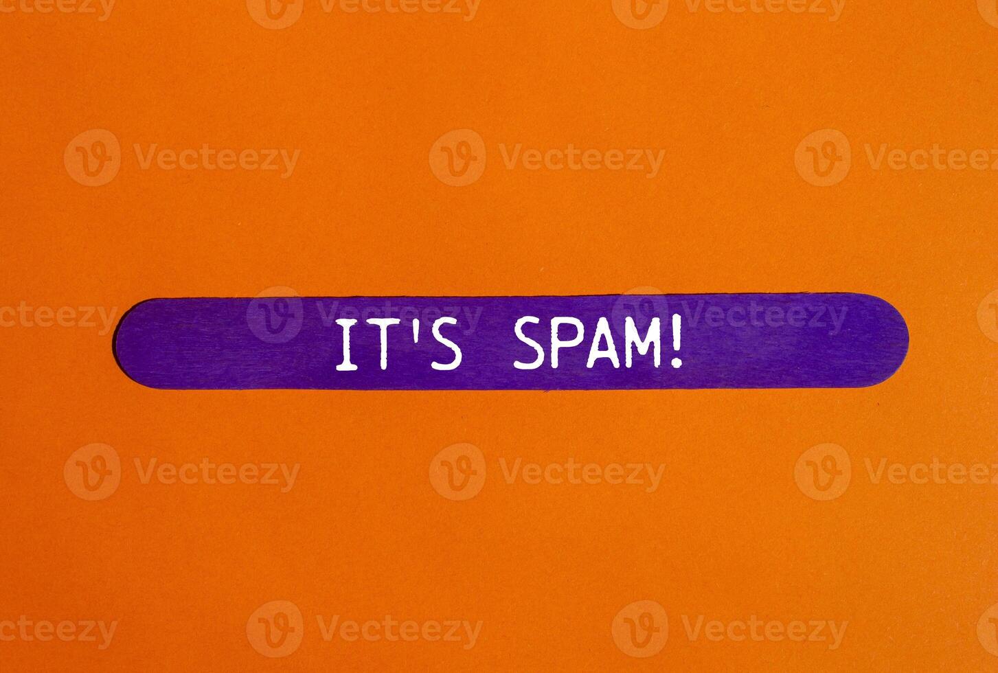 It's spam message written on purple wooden stick with orange background. Conceptual it's spam symbol. Copy space. photo