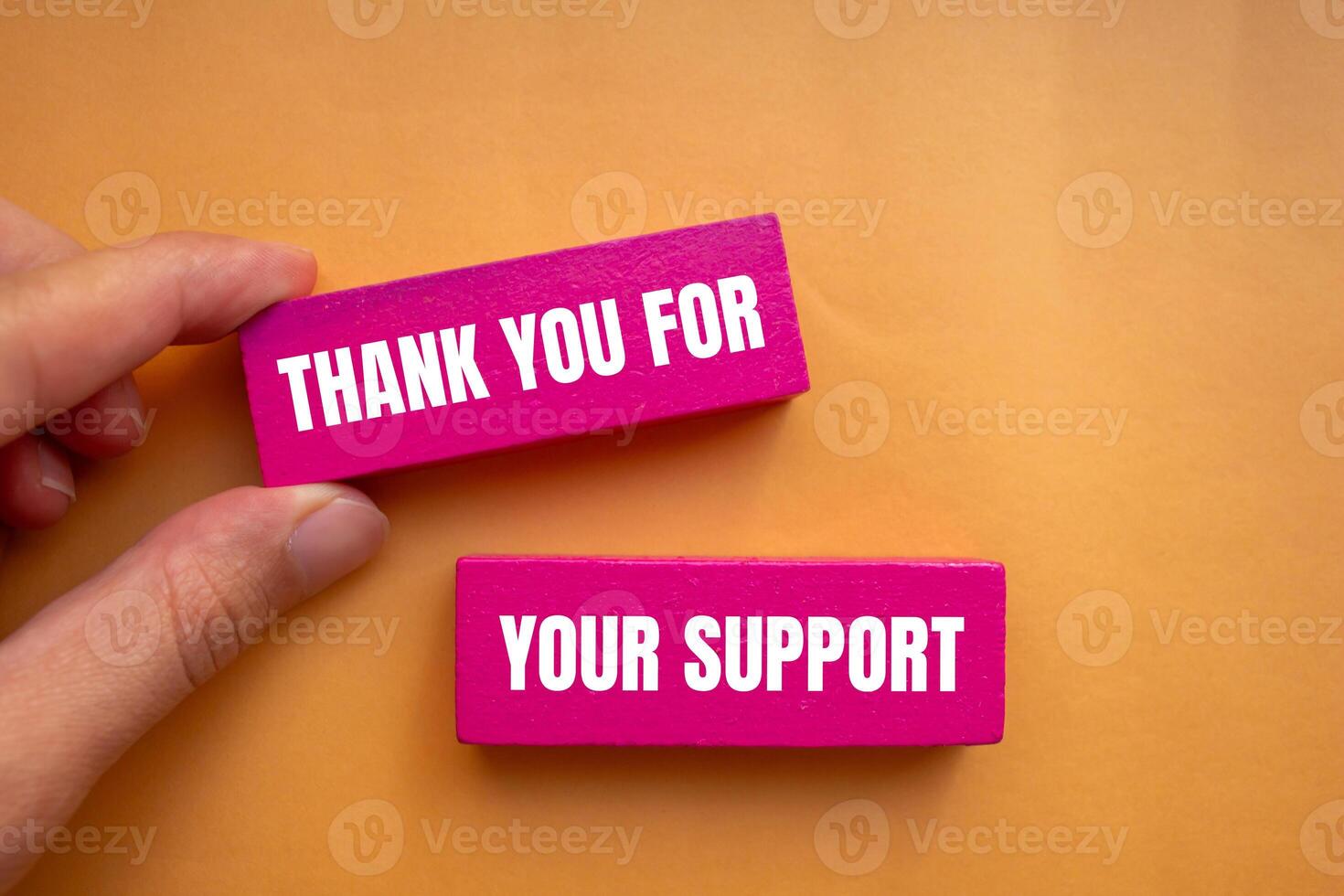 Thank you for your support message written on pink wooden blocks with orange background. Conceptual thank you for your support symbol. Copy space. photo
