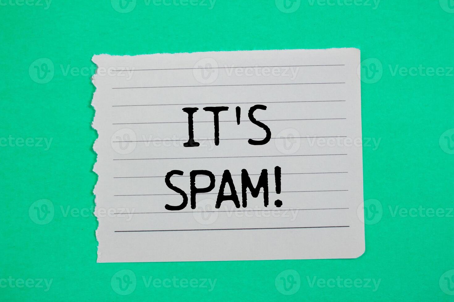 It's spam message written on ripped torn paper piece with green background. Conceptual it's spam symbol. Copy space. photo