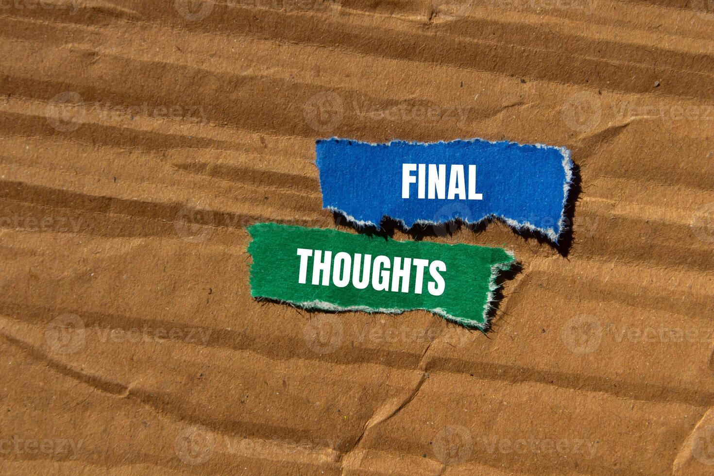 Final thoughts message written on ripped torn paper pieces with cardboard background. Conceptual final thoughts symbol. Copy space. photo