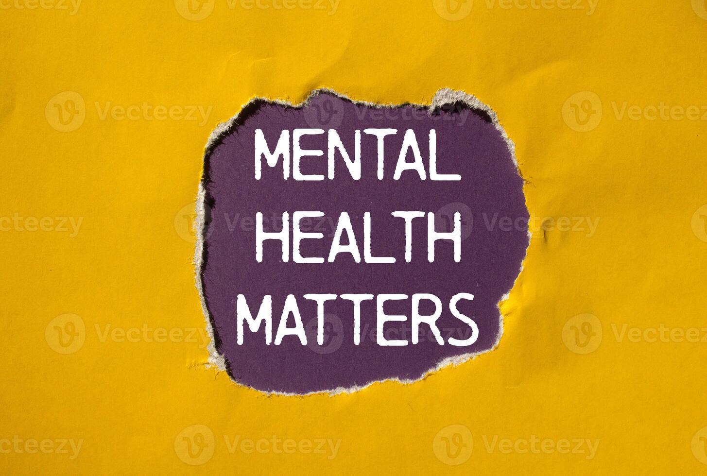 Mental health matters message written on ripped torn yellow paper with purple background. Conceptual mental health matters symbol. Copy space. photo
