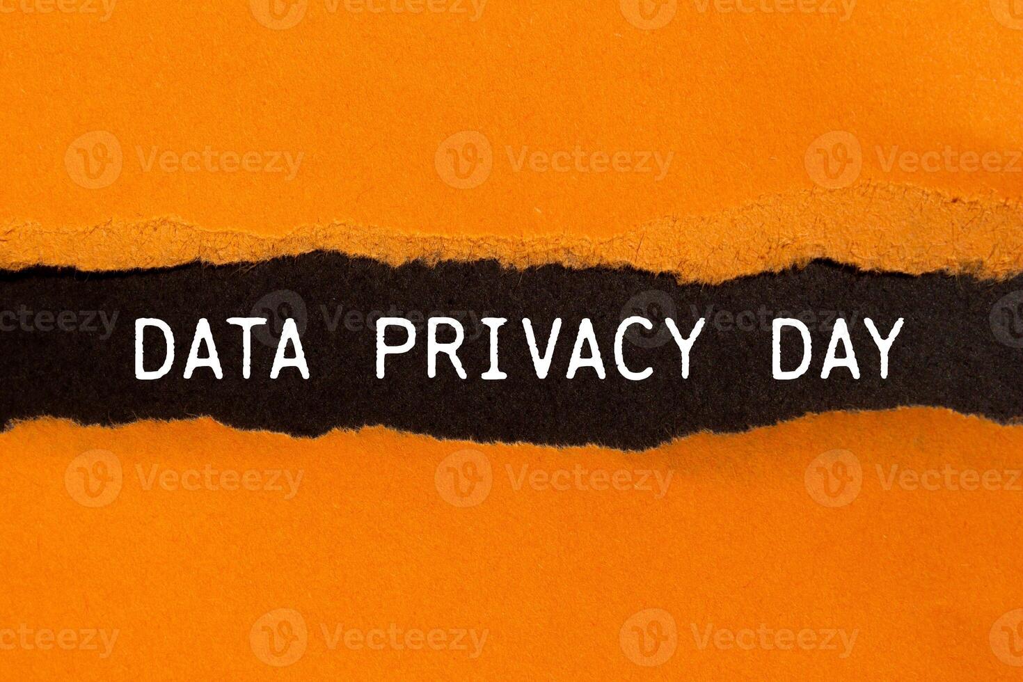 Data privacy day message written on ripped torn orange paper with black background. Conceptual data privacy day symbol. Copy space. photo