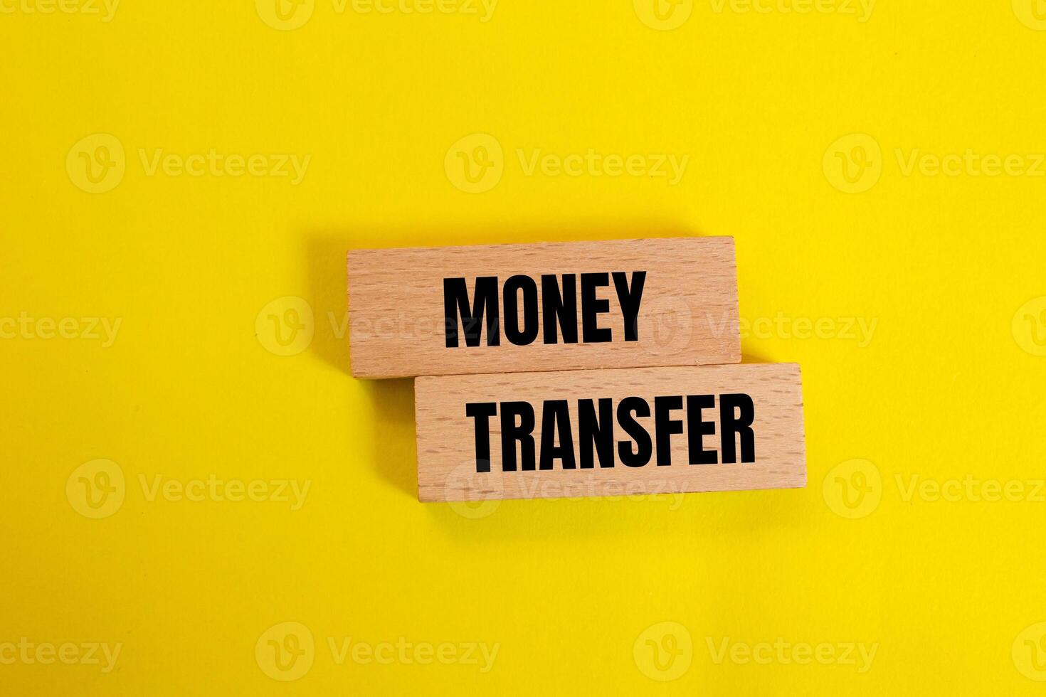 Money transfer message written on wooden blocks with yellow background. Conceptual money transfer symbol. Copy space. photo
