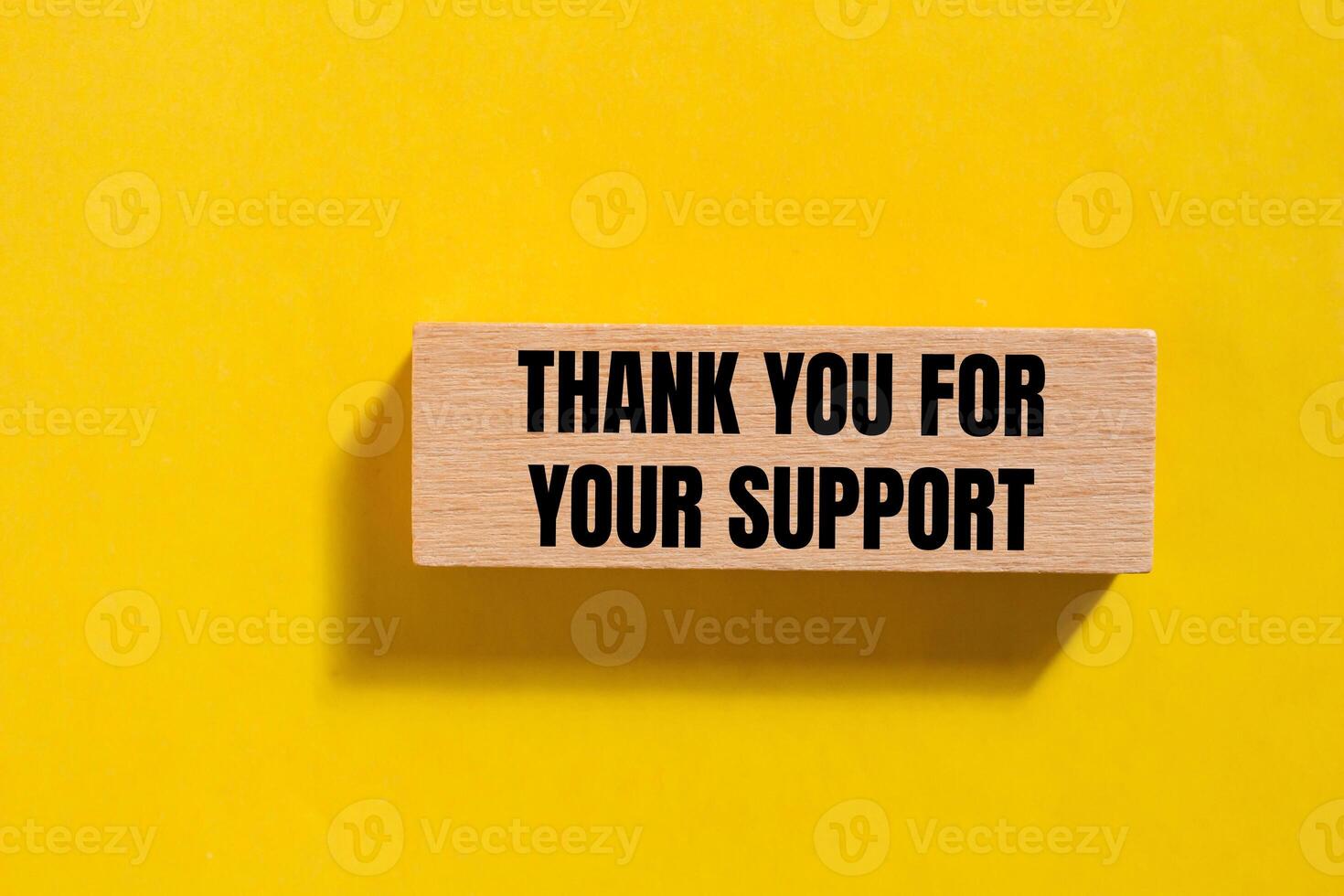Thank you for your support message written on wooden block with yellow background. Conceptual thank you for your support symbol. Copy space. photo