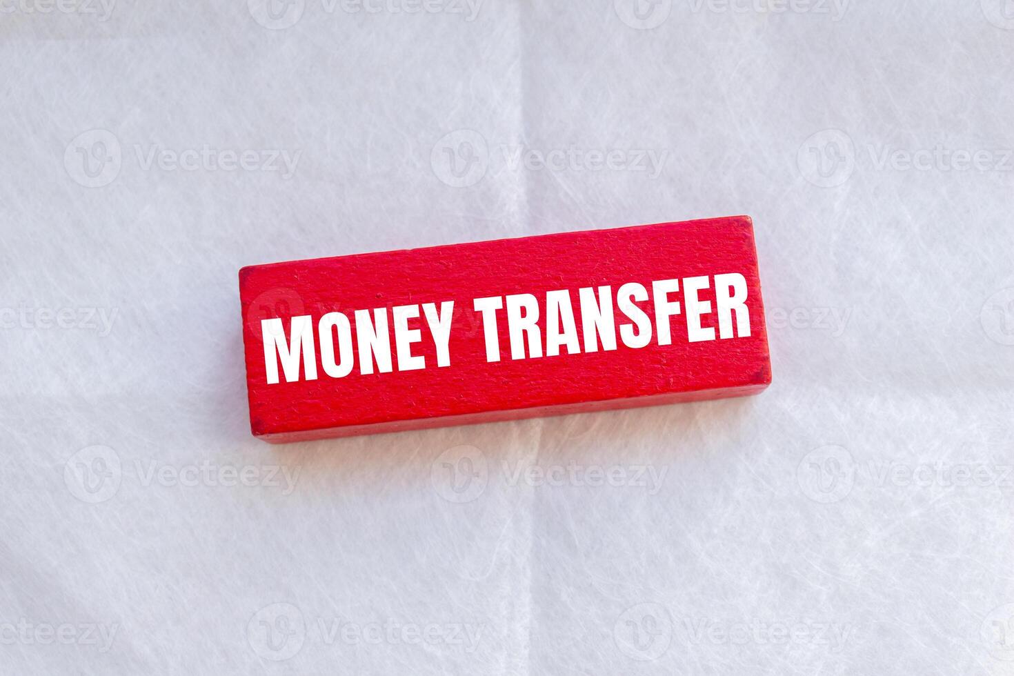 Money transfer message written on wooden red block with white background. Conceptual money transfer symbol. Copy space. photo