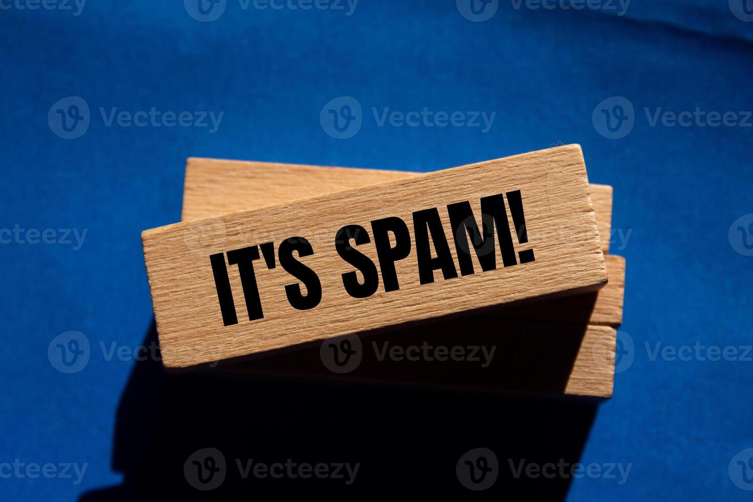 It's spam message written on wooden blocks with blue background. Conceptual it's spam symbol. Copy space. photo