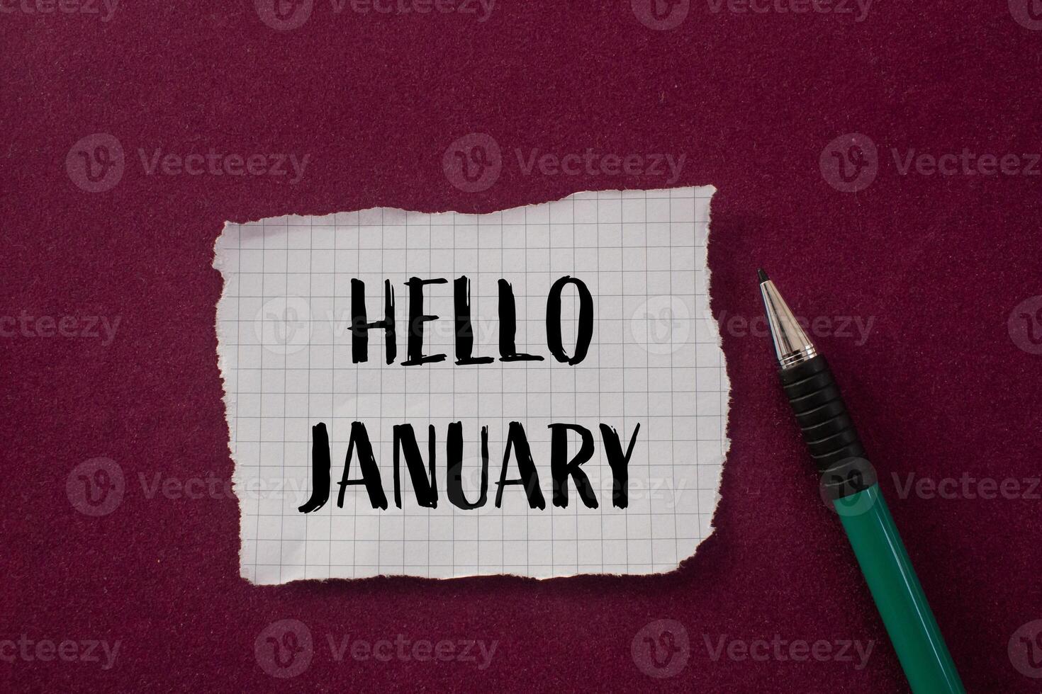 Hello january message written on ripped torn paper piece with purple background. Conceptual hello january symbol. Copy space. photo