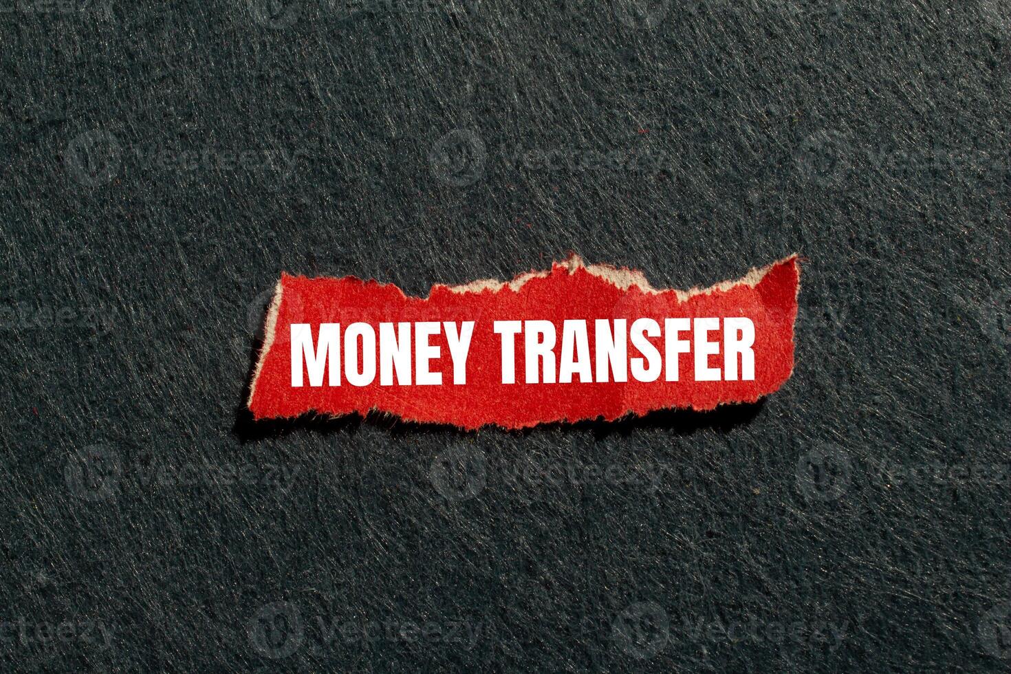 Money transfer message written on ripped torn red paper piece with gray background. Conceptual money transfer symbol. Copy space. photo