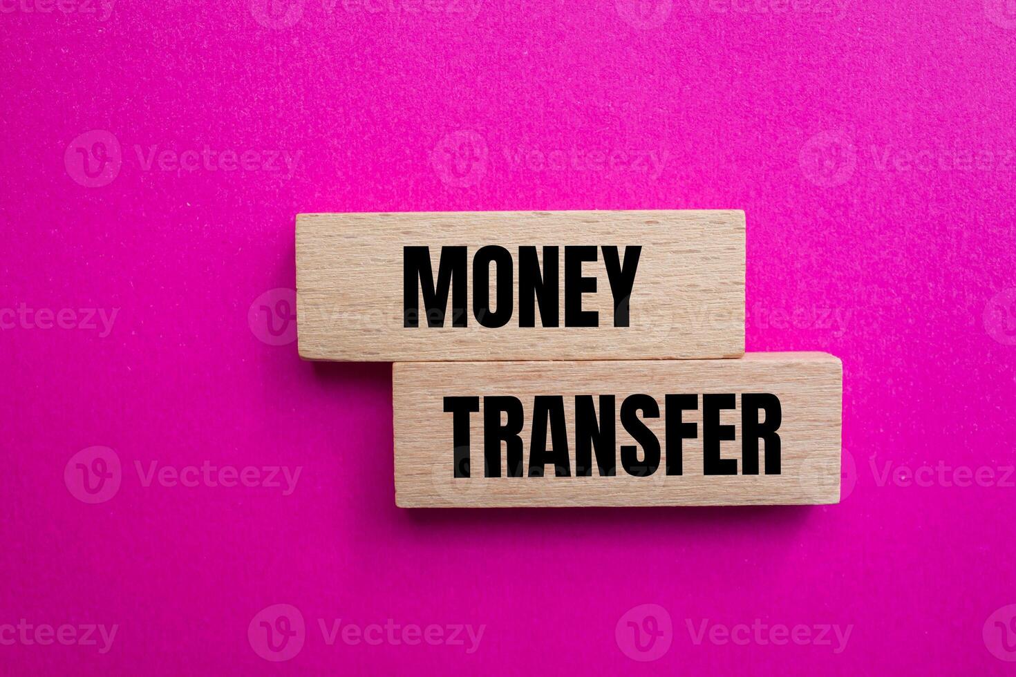 Money transfer message written on wooden blocks with pink background. Conceptual money transfer symbol. Copy space. photo