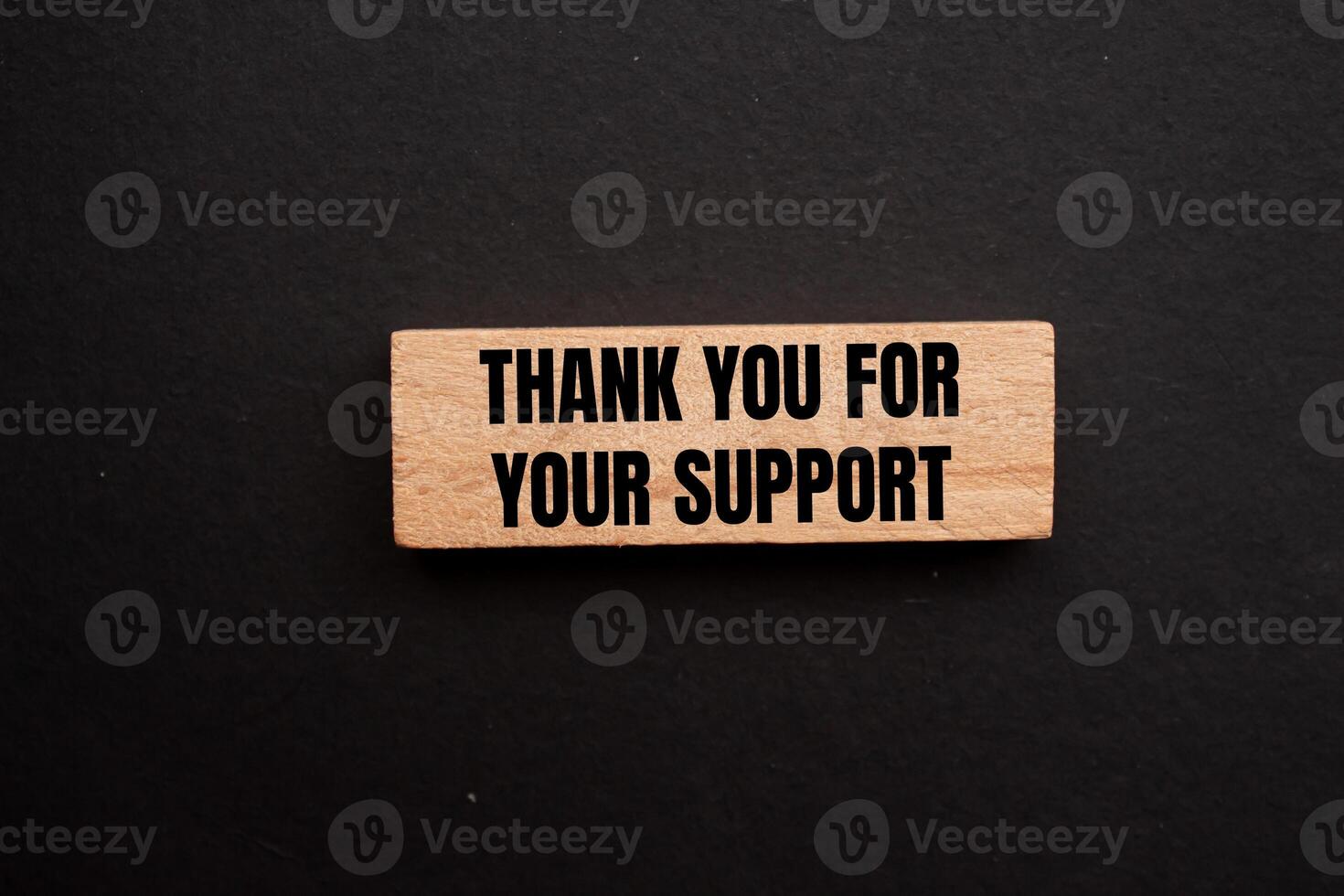 Thank you for your support message written on wooden block with black background. Conceptual thank you for your support symbol. Copy space. photo