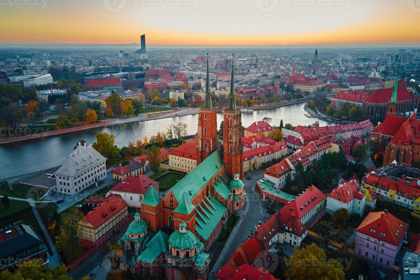 Aerial view of European city with Gothic churches and historic architecture in autumn season. St. John Cathedral on Ostrow Tumski at sunset. Cityscape panorama of Wroclaw, Poland photo