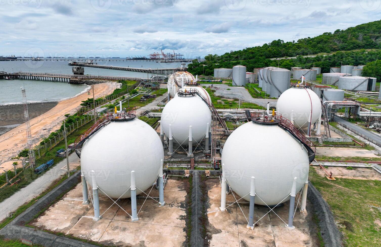 Industrial gas storage tank. LNG or liquefied natural gas storage tank. Gas tank in petroleum refinery. Natural gas storage industry. Energy infrastructure and petroleum reserves in global market. photo
