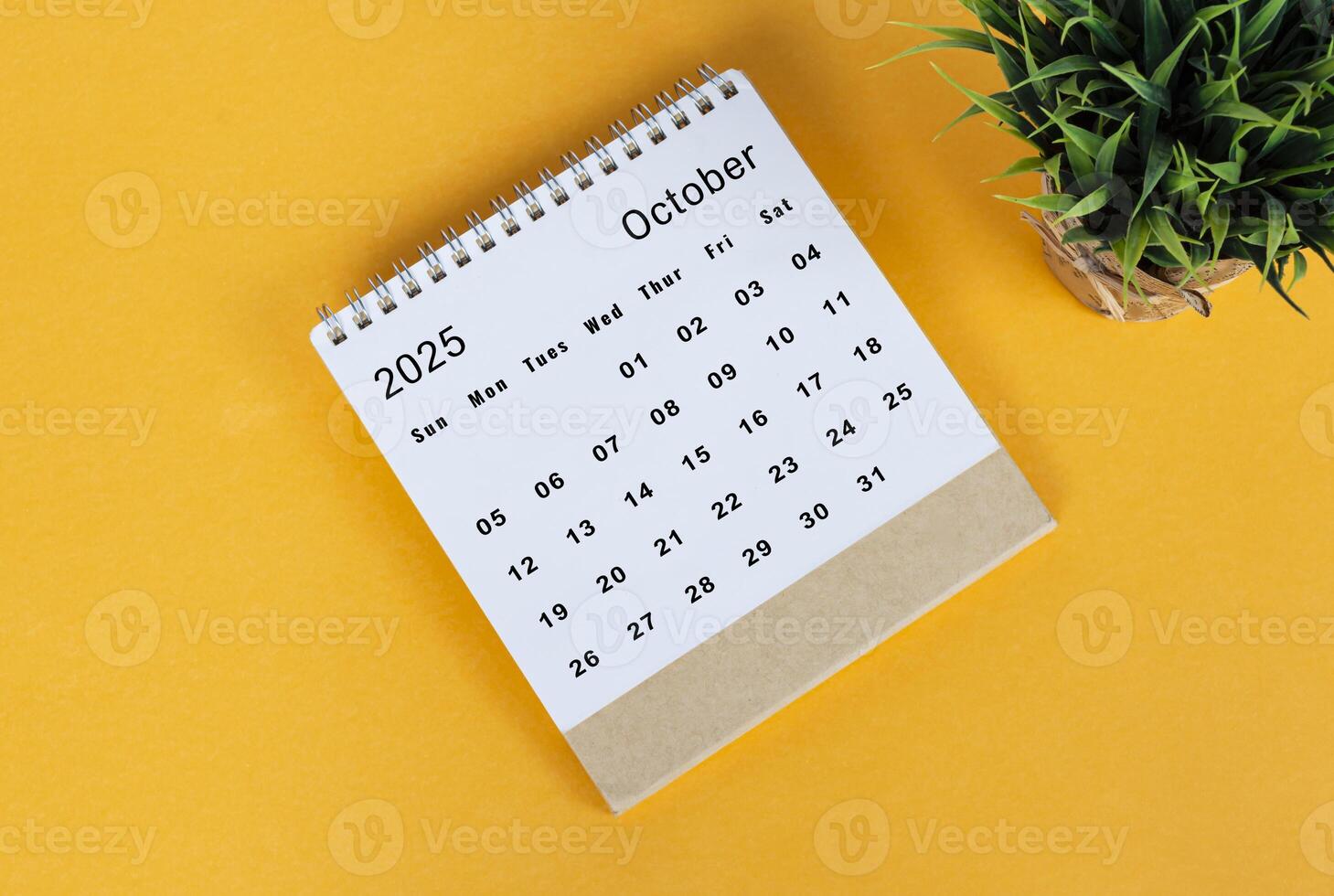 October 2025 desk calendar on yellow background. Directly above. Flat lay photo