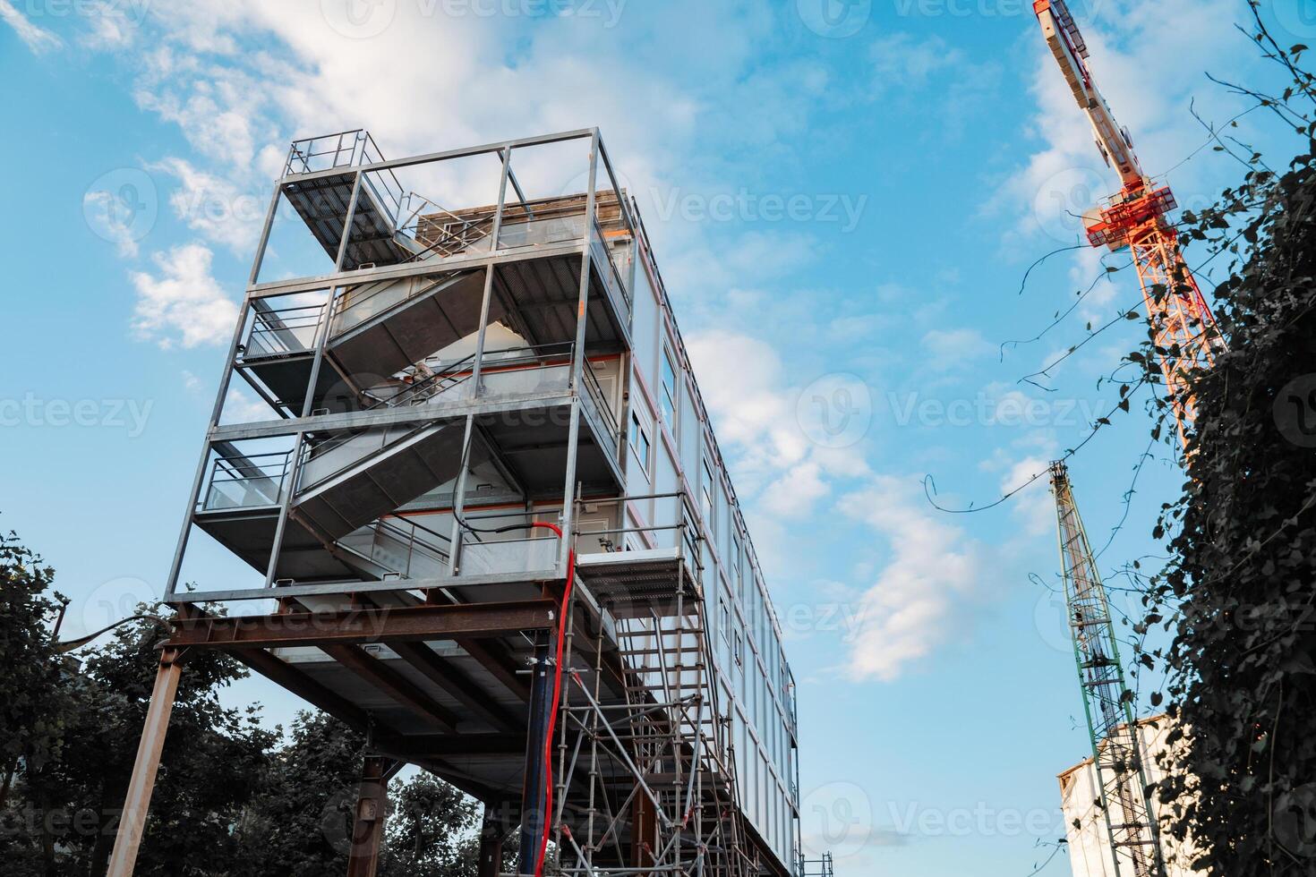 Urban Construction Site With Crane and Blue Sky Background photo