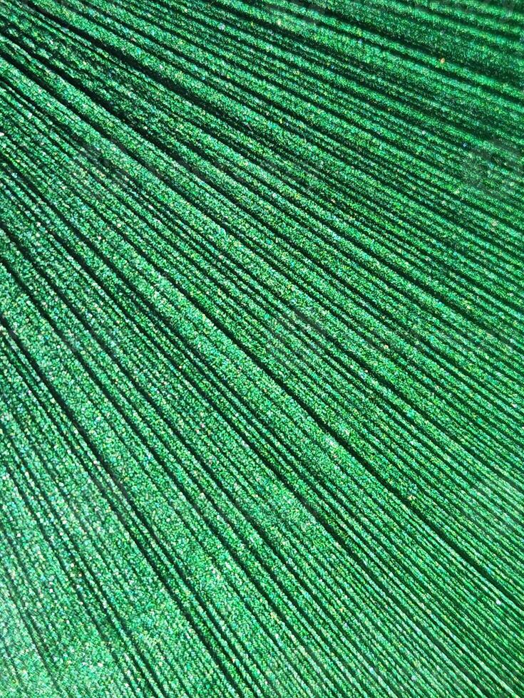 Green festive background with glitter. Background of green glitter threads photo