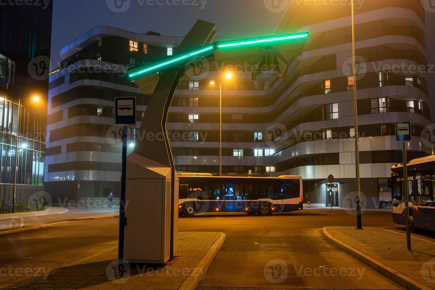 An electric bus stands at an empty bus stop and charges, a close up photo