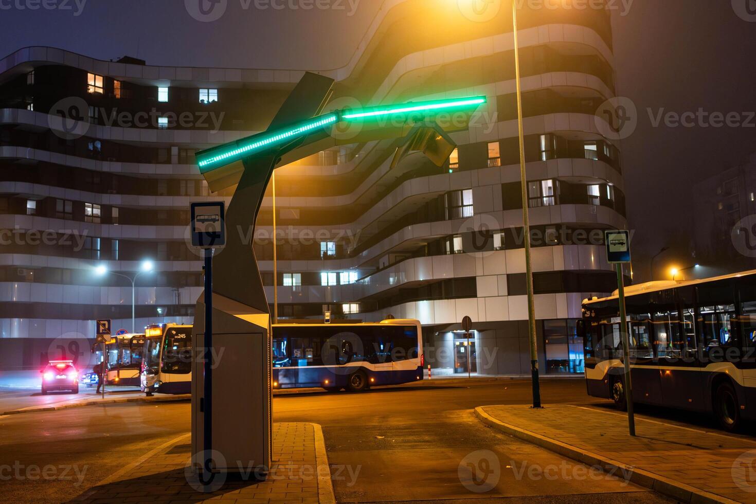 An electric bus stands at an empty bus stop and charges, a close up photo