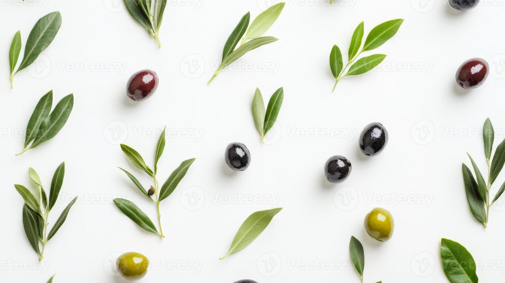 Various olives and green leaves placed on a clean white background create a fresh look photo