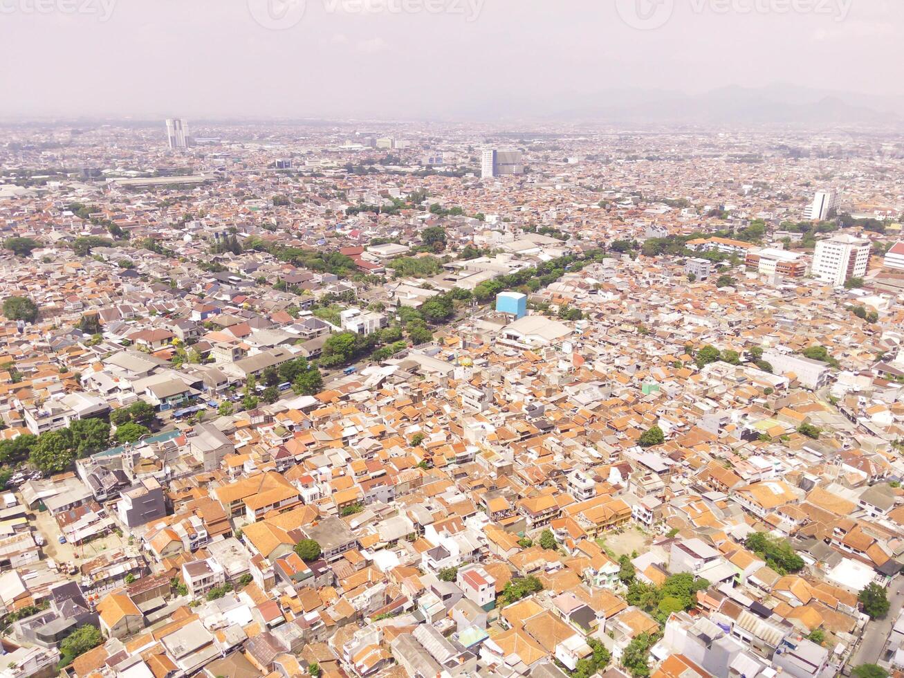 Hundreds of thousands of houses in densely populated City in South East Asia. Townscape of Bandung city, Indonesia. Overpopulation Problem in Indonesia. Aerial Landscape photo