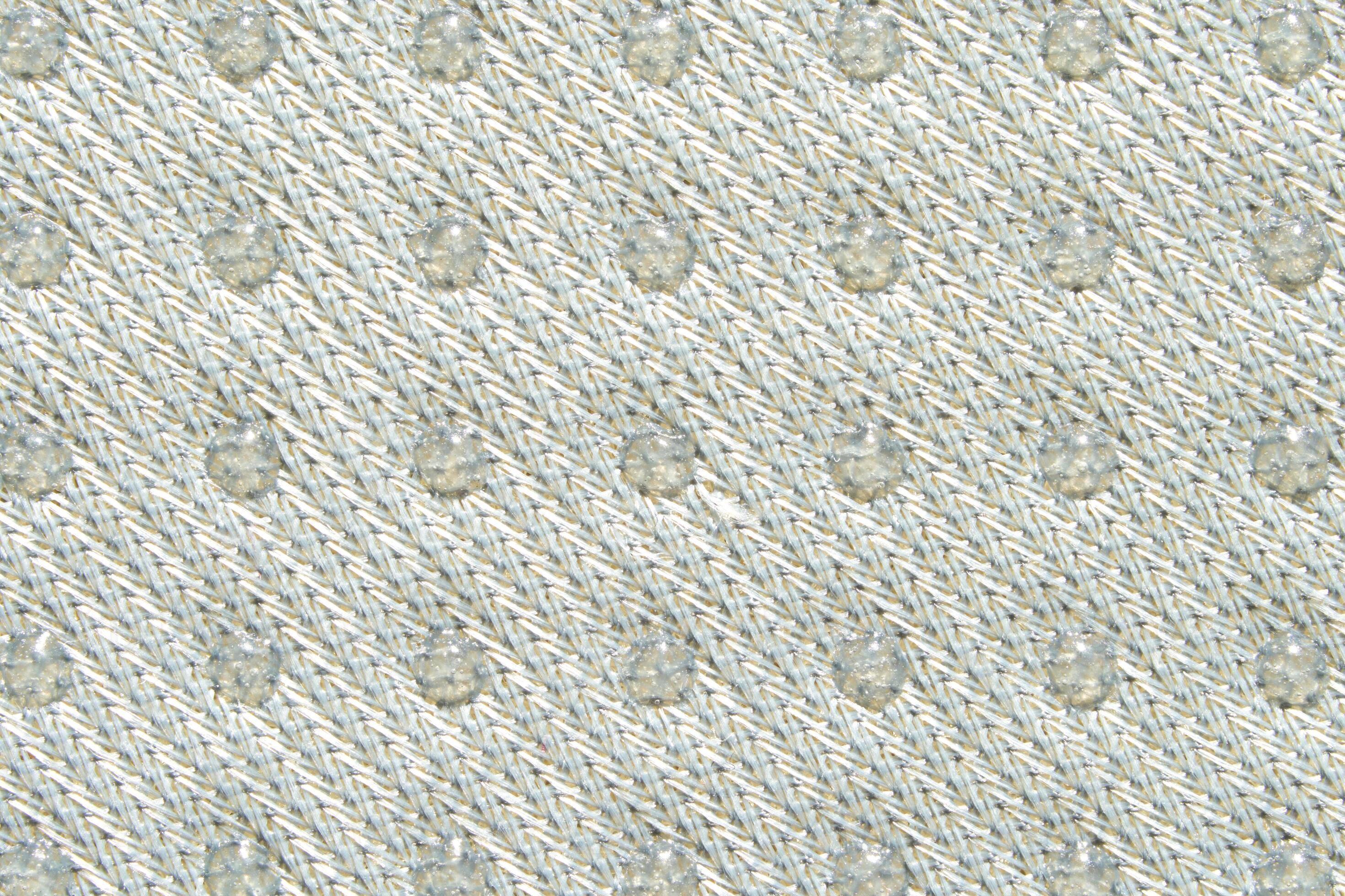 Textured knitted fabric with raised pattern in subtle beige tones for