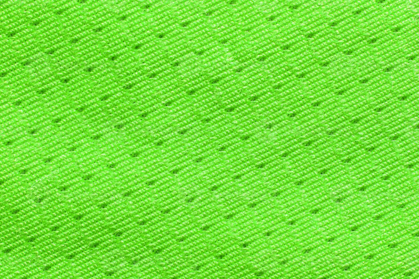 Bright neon green textured fabric with intricate zigzag pattern for fashion and design. photo